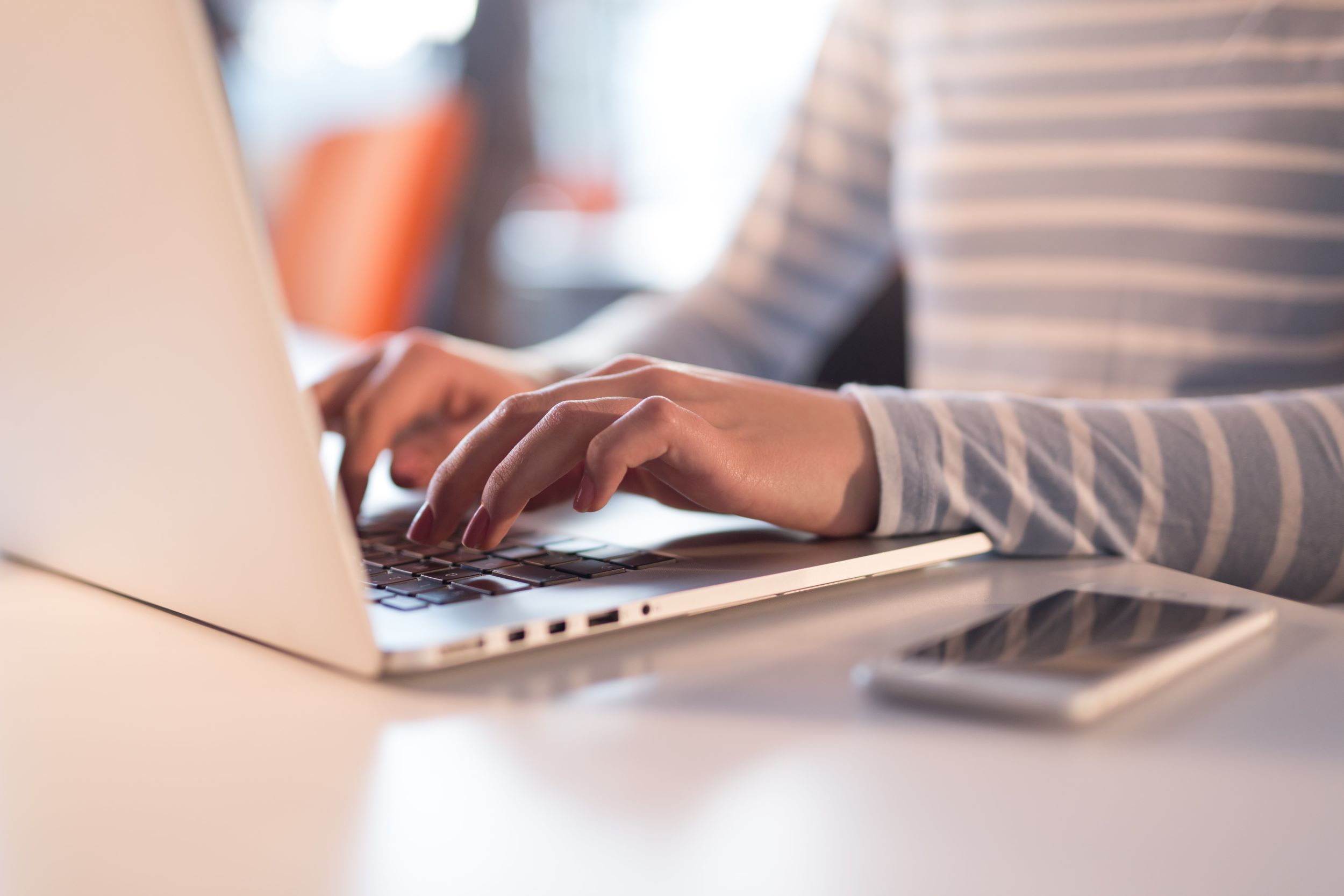 young professional showing typing on a laptop - close-up picture